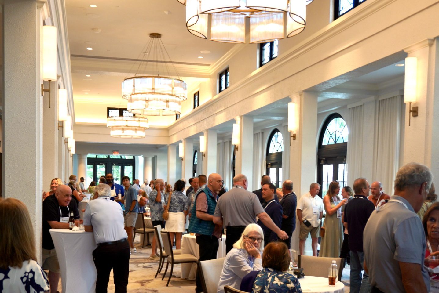 DSC00023 IDeACOM members talking in small groups at the opening<br />
reception of the 2026 conference in St. Petersburg, Florida